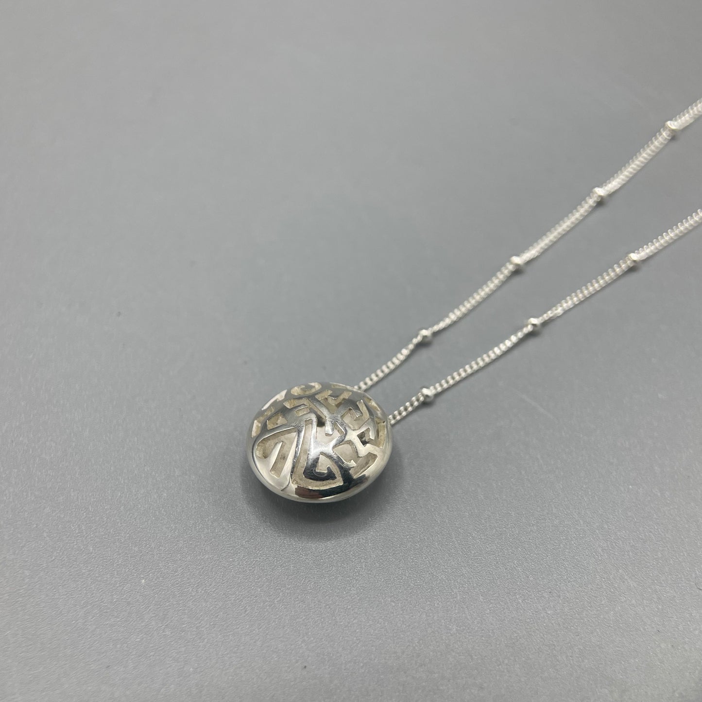 Kathryn Arbon Small hand pierced domed pendant