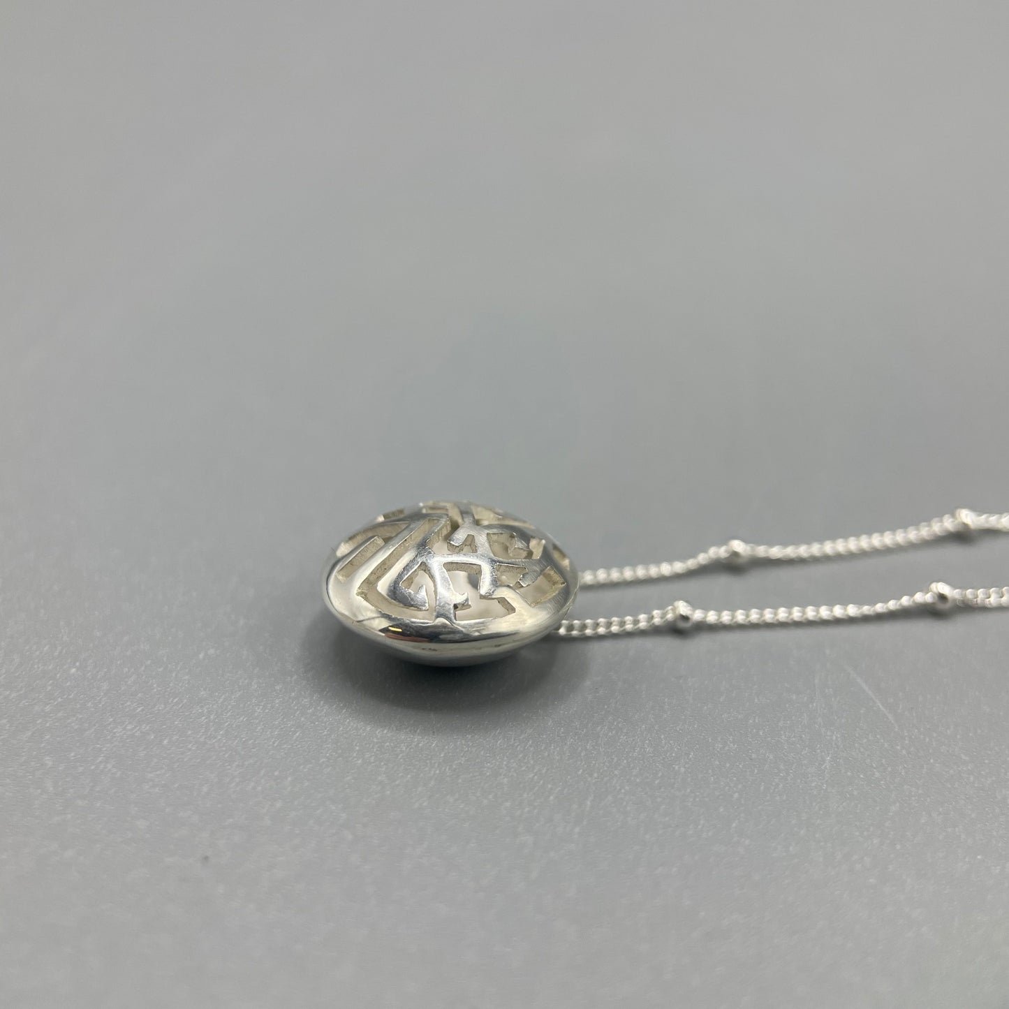 Kathryn Arbon Small hand pierced domed pendant