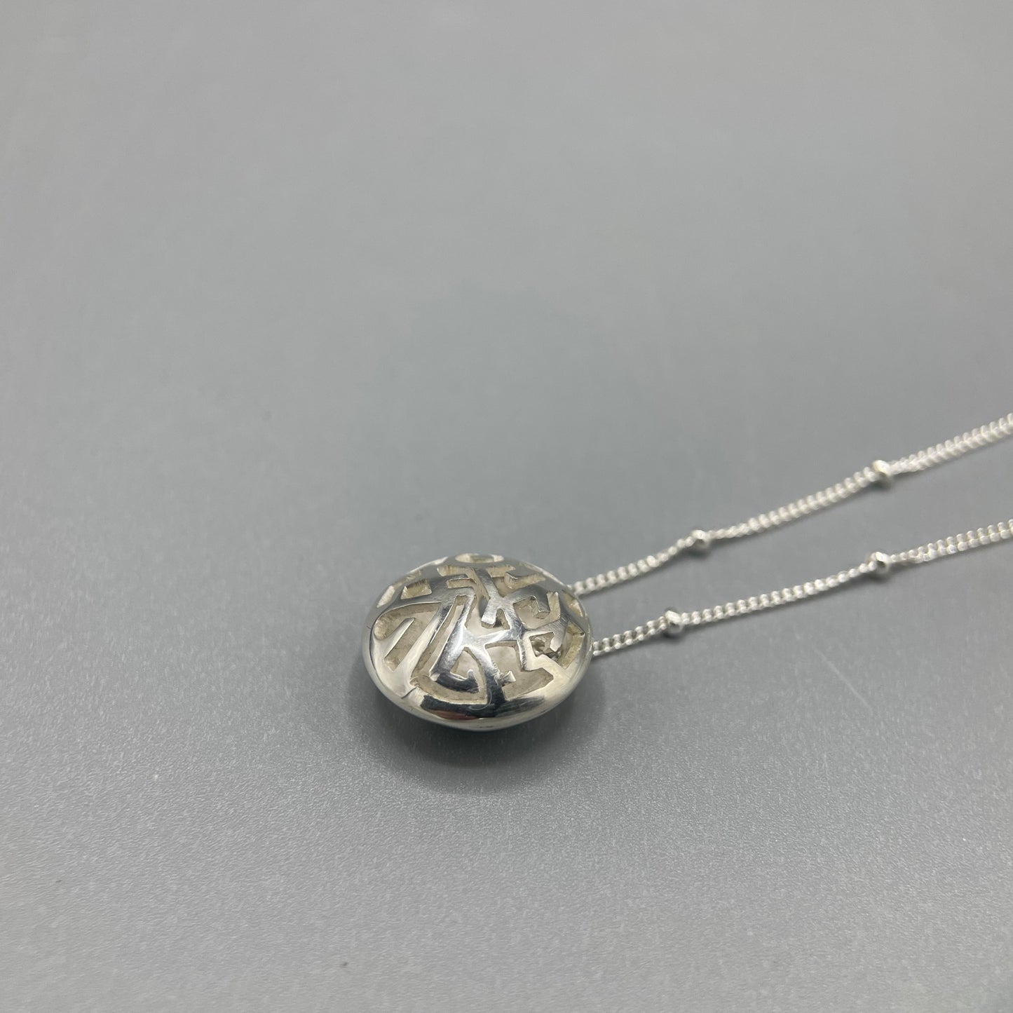 Kathryn Arbon Small hand pierced domed pendant