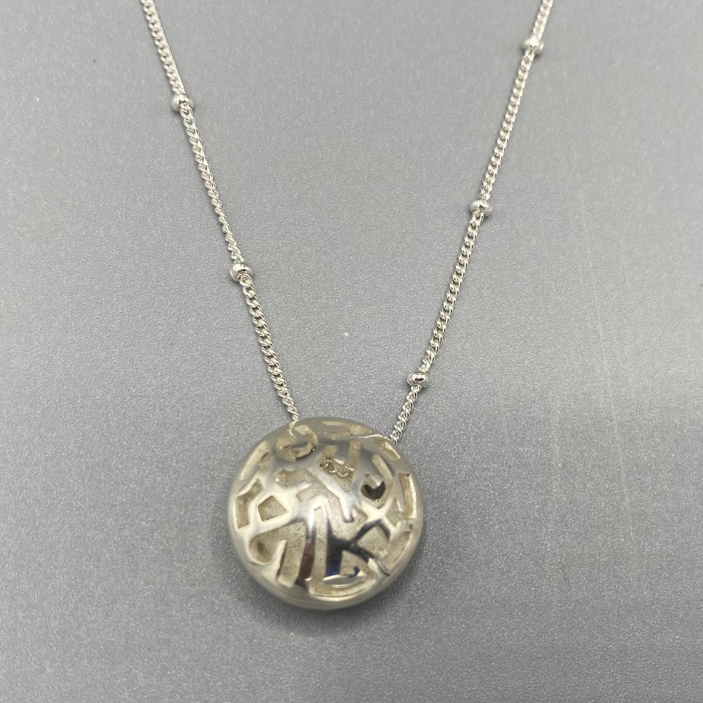 Kathryn Arbon Small hand pierced domed pendant