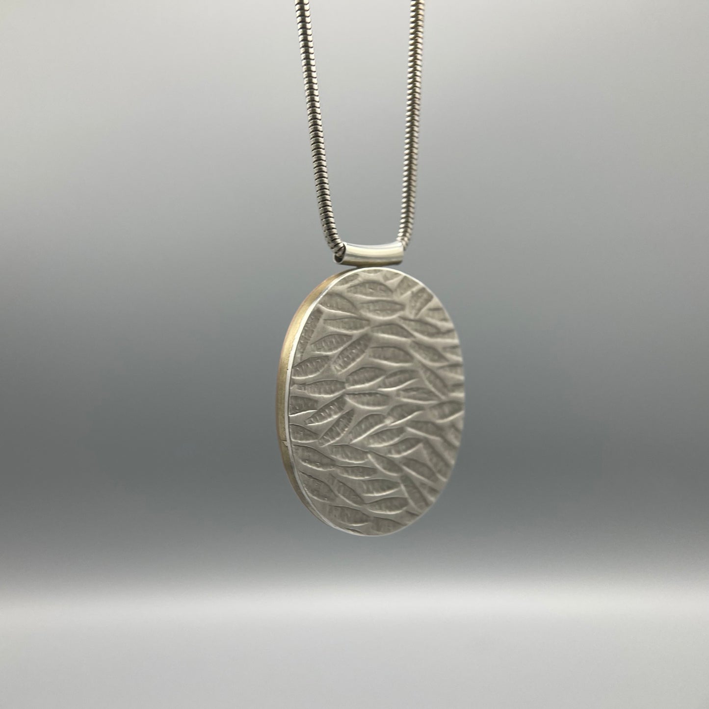 Papermetal Embossed Petals Reversible Oval Pendant