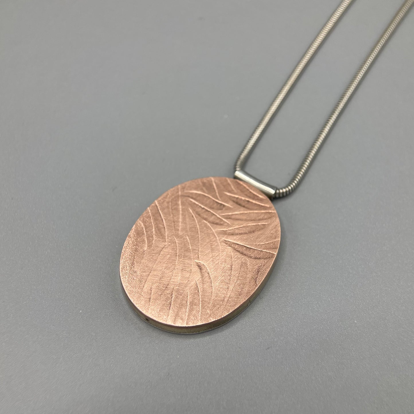 Papermetal Embossed Petals Reversible Oval Pendant