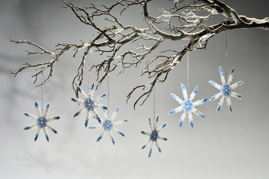 glass snowflake decorations hanging off a tree