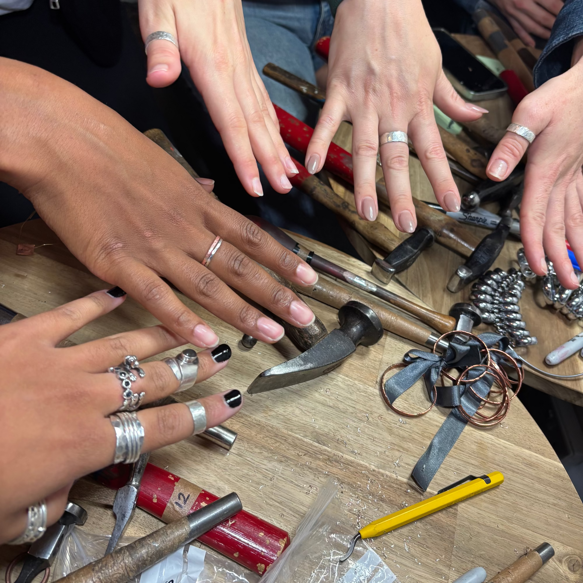 Hands showing off their rings at OneB Get Hammered
